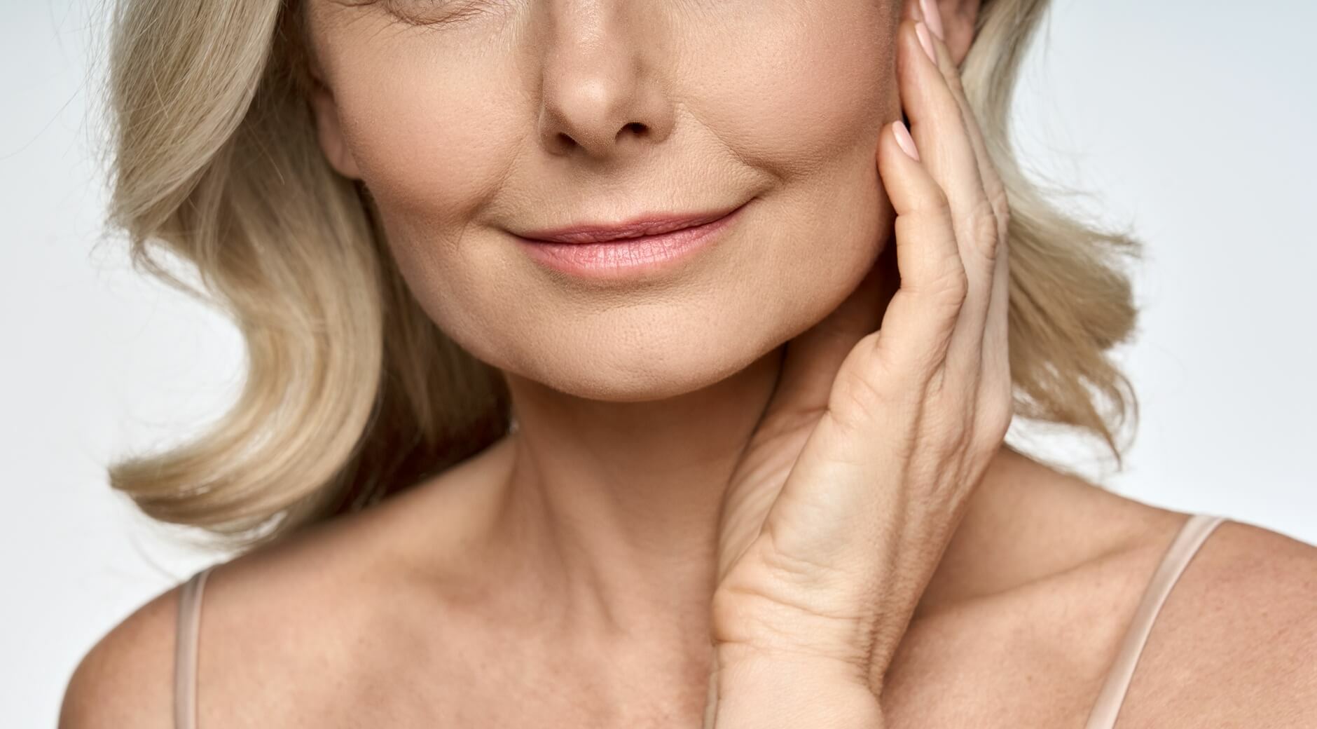 Mature woman with smooth, defined cheekbones and natural facial volume after Restylane filler treatment
